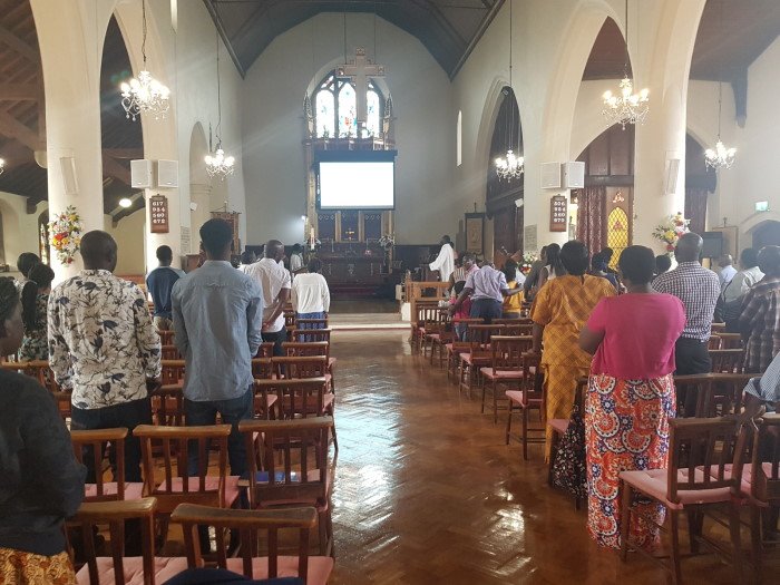 Ekkanisa y’Oluganda congregation worshipping together